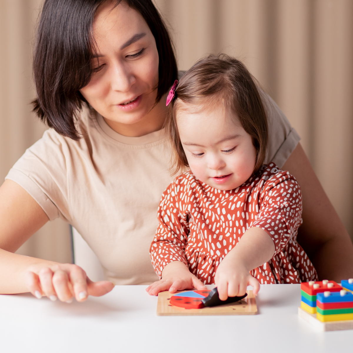 Special education teacher working one-on-one with a student in a classroom setting