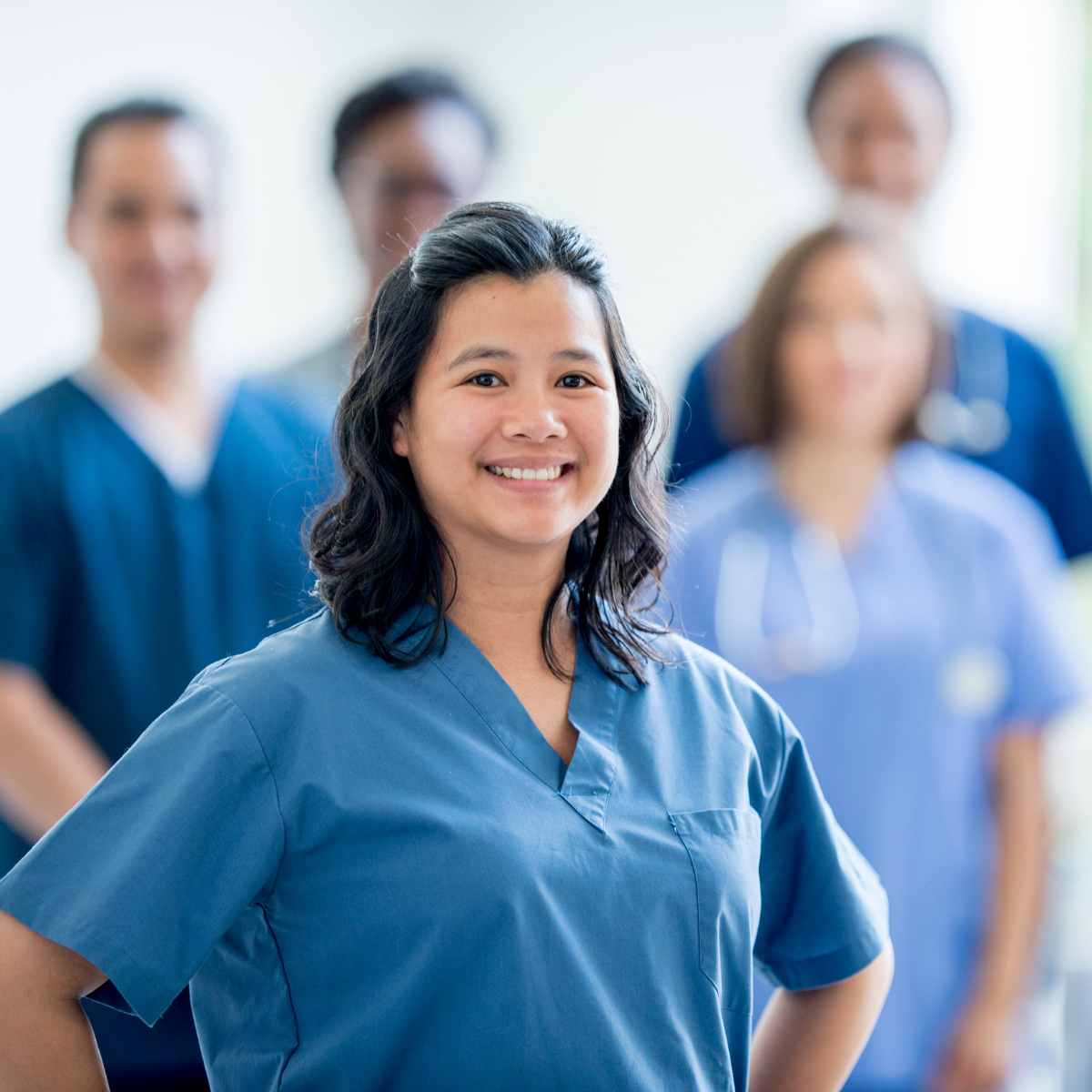 LPN, RN, and travel therapist collaborating in a clinical care setting