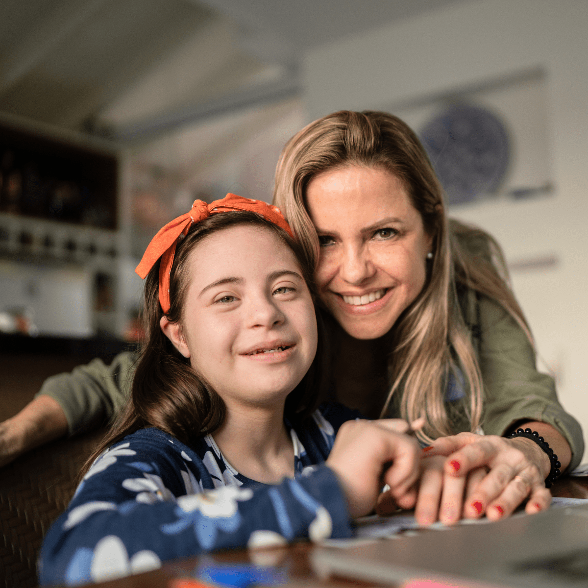 Smiling mother and daughter with Down syndrome representing special education inclusion and family support.