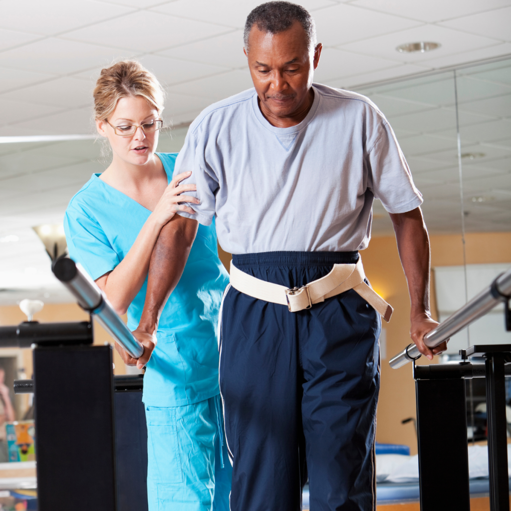 Physical therapy professional supporting a patient with gait training using a safety belt in a rehabilitation facility. 