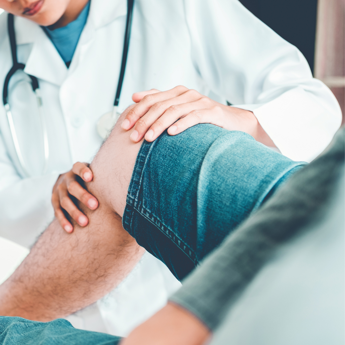 Physical therapist conducting a knee evaluation during a rehabilitation session.