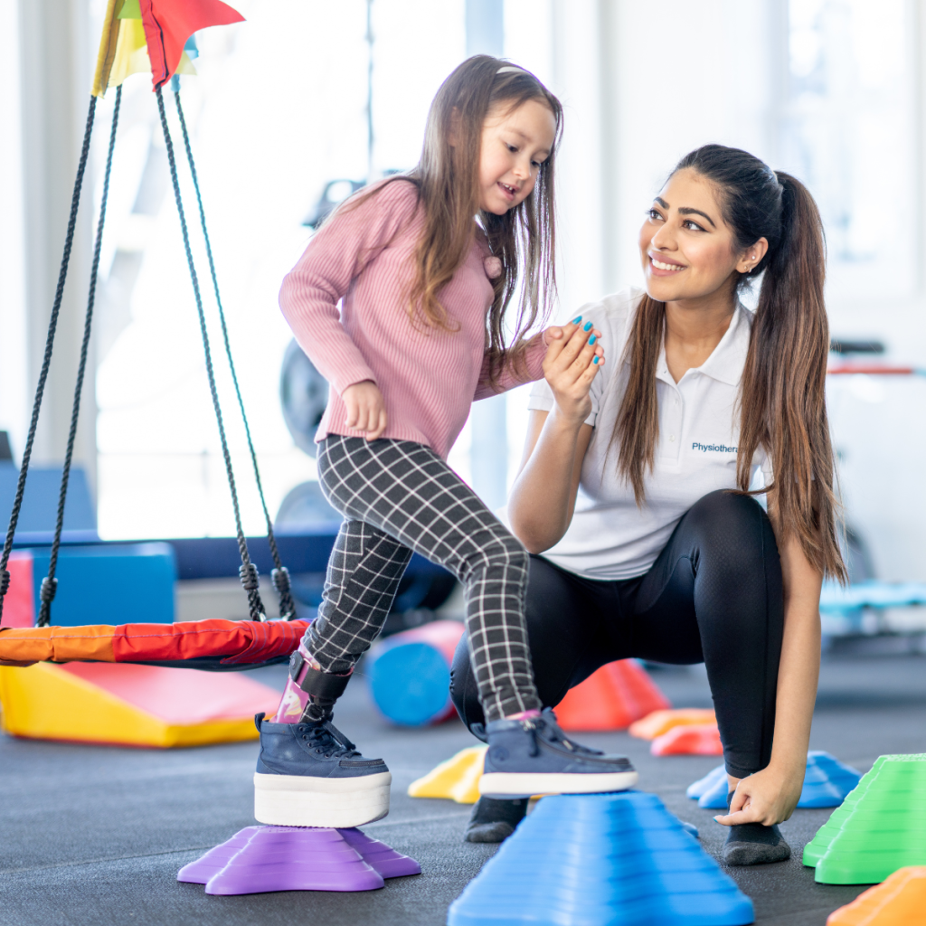 Pioneer Pediatric Travel Therapy A young girl practicing balance on colorful blocks during a Pioneer pediatric travel therapy session.