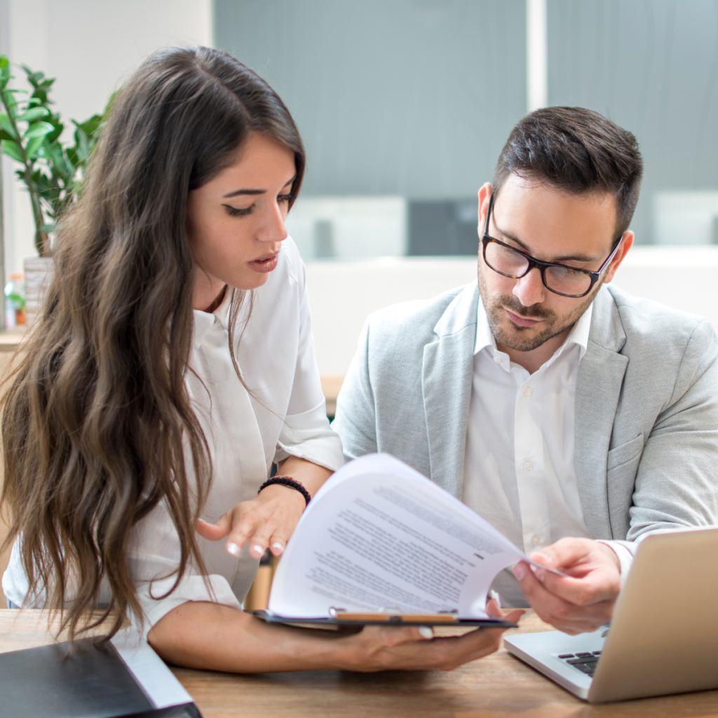 collaborative-behavioral-health-treatment-planning Two healthcare clinicians reviewing patient files and psychological assessments to develop a comprehensive, holistic treatment plan.