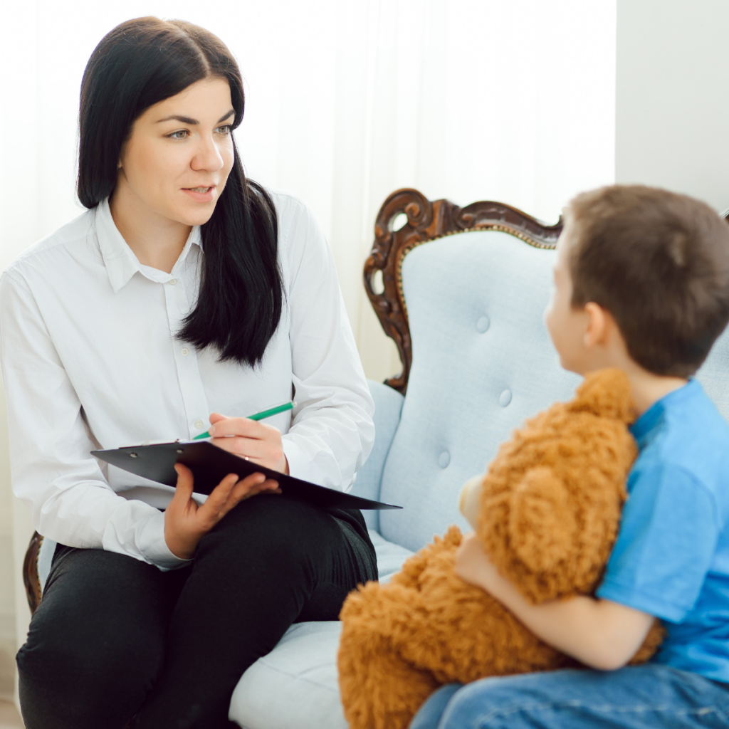 pediatric-psychology-importance-in-healthcare A female psychologist engaging in a supportive consultation with a young child, highlighting the role of behavioral health in pediatric medical outcomes.