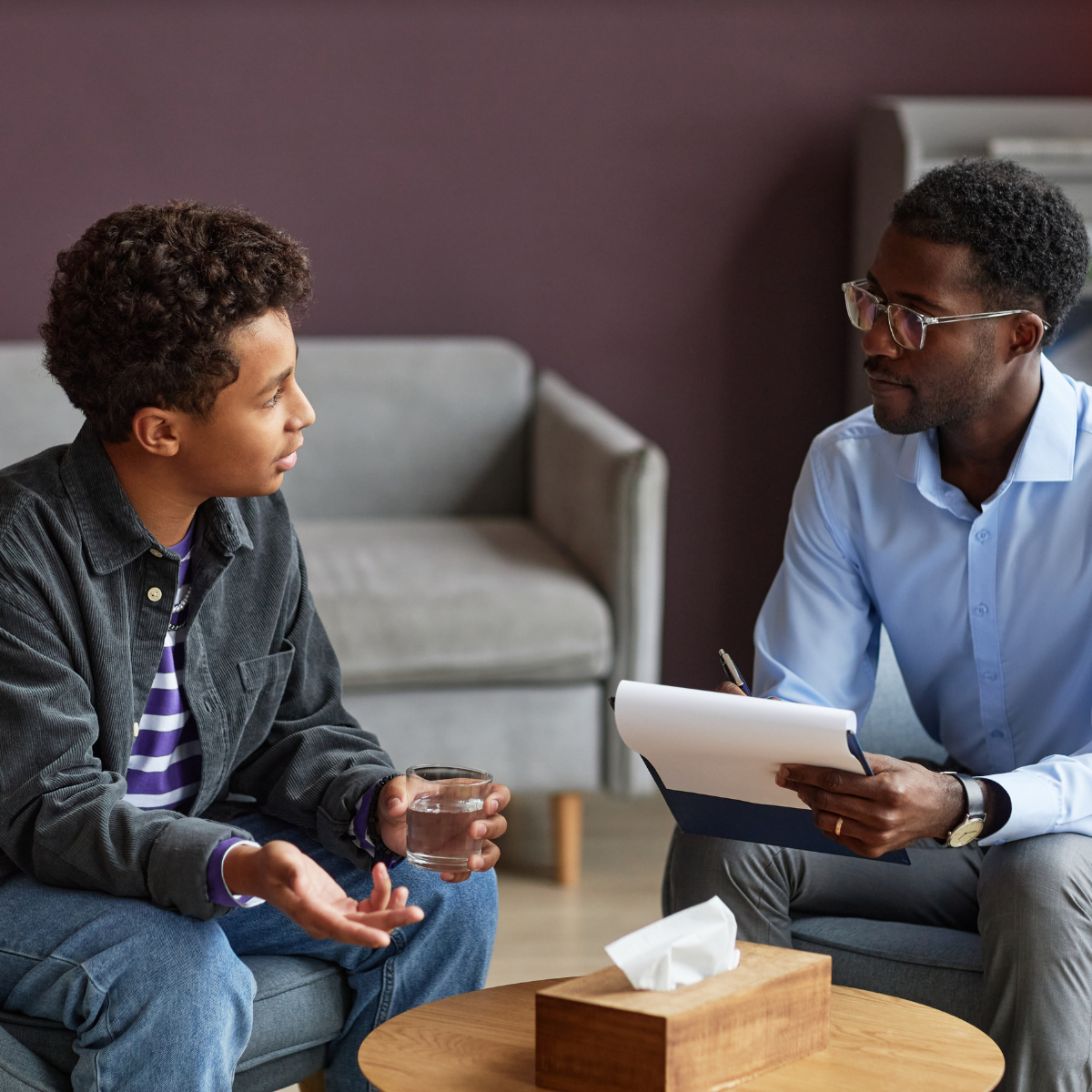 Psychologist reviewing notes with a patient during a one-on-one therapy session