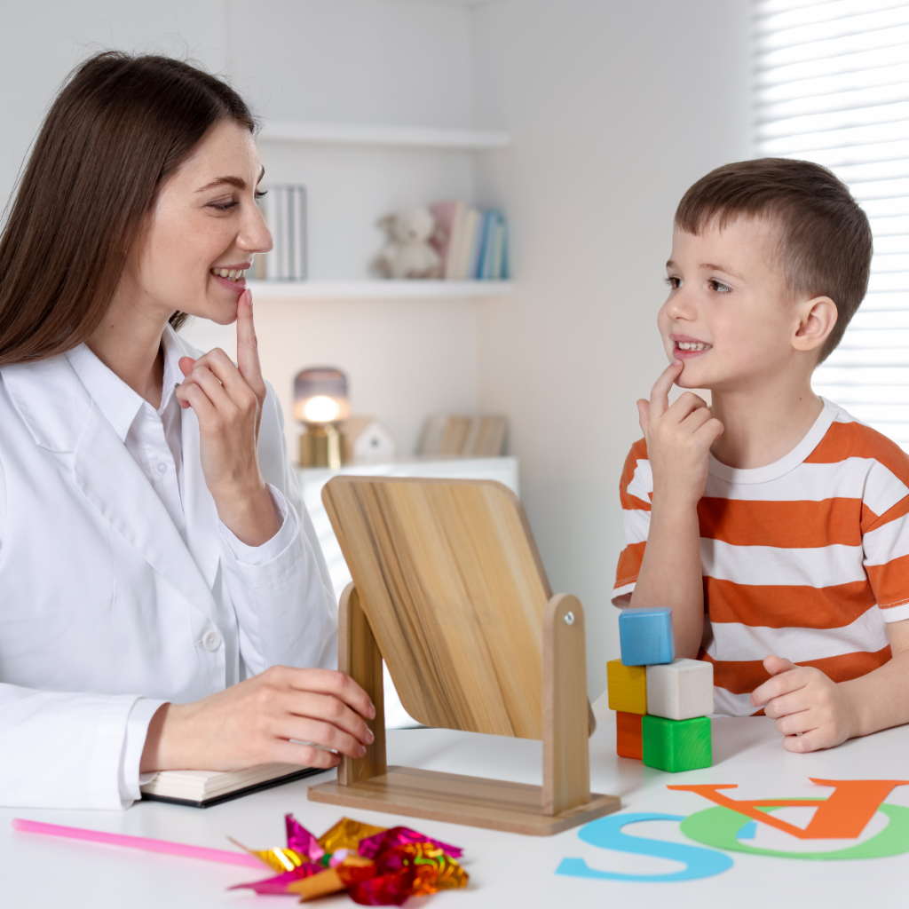 A speech therapist uses a mirror to teach a young boy articulation techniques, illustrating the technical complexity of speech-language pathology practice. 