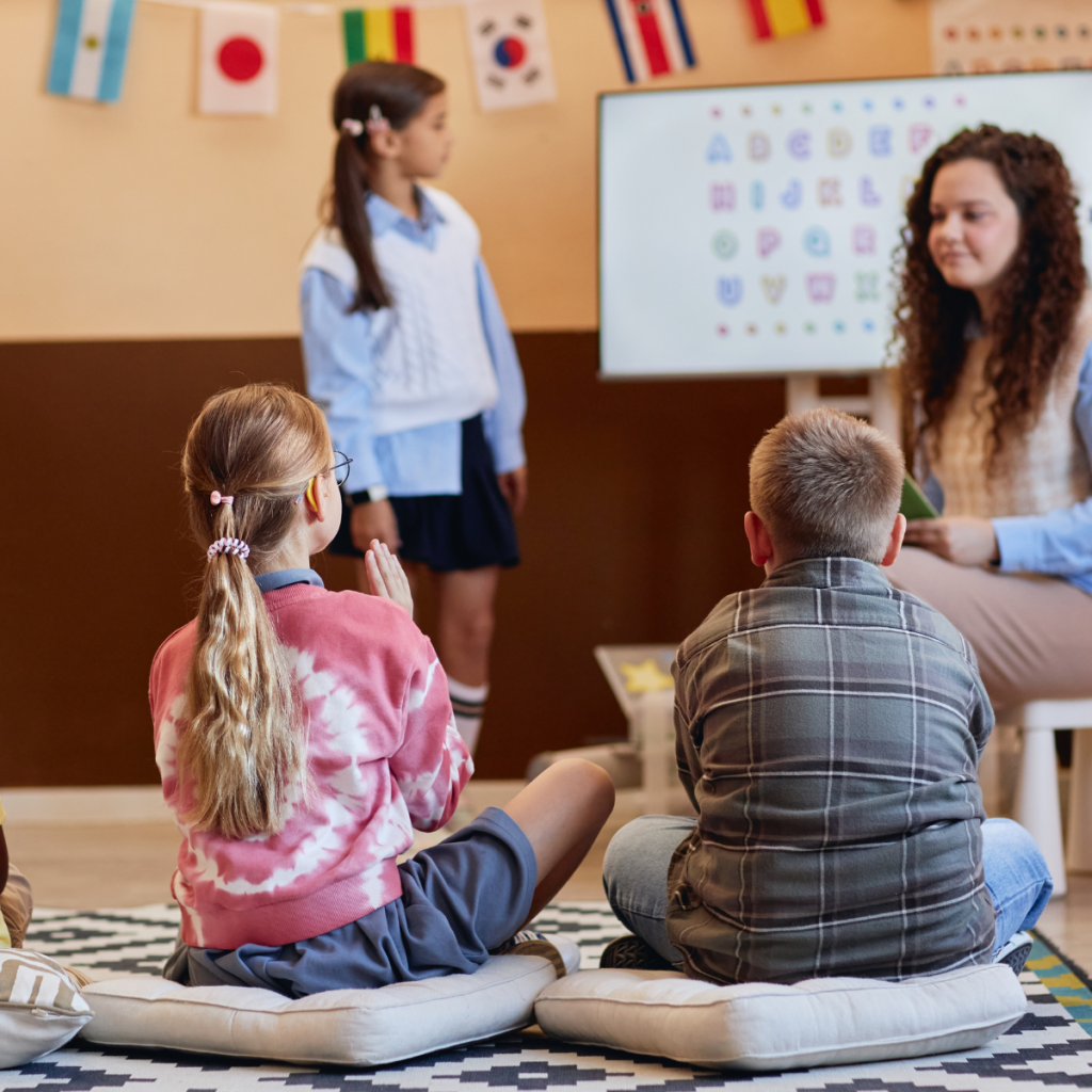 school-based-slp-job-market-outlook-2026 A smiling SLP professional working with elementary students in a classroom, highlighting the 15-18% projected growth in educational speech therapy roles.