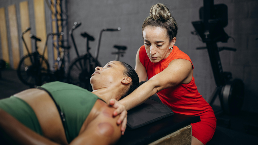 Factors Influencing Sports Physical Therapist Compensation A physical therapist performing cupping therapy on an athlete’s shoulder in a gym setting to improve recovery and performance.
