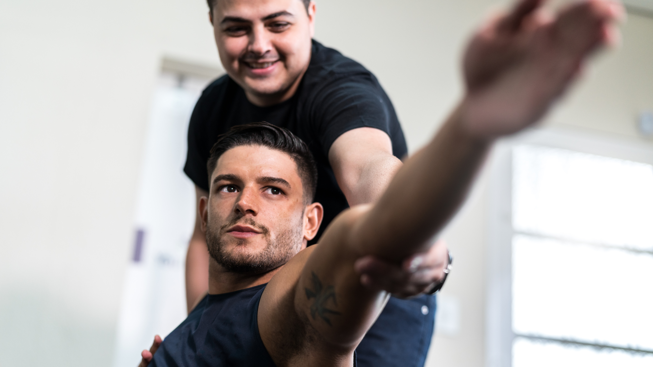 Sports physical therapist treating patient during rehab, demonstrating career path and salary potential