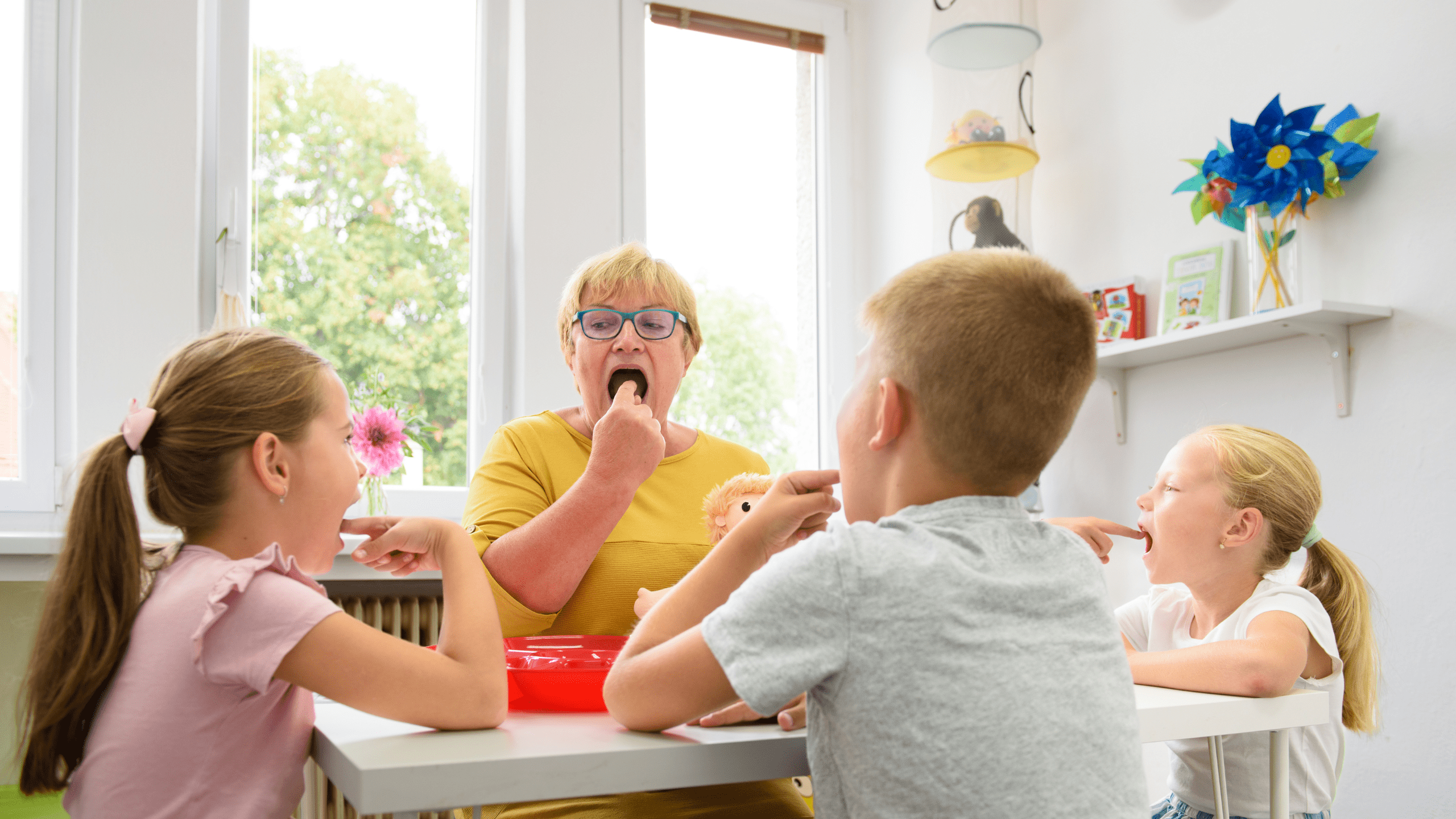 Children speech therapy concept. Children practicing correct pronunciation with a female speech therapist. Group therapy.