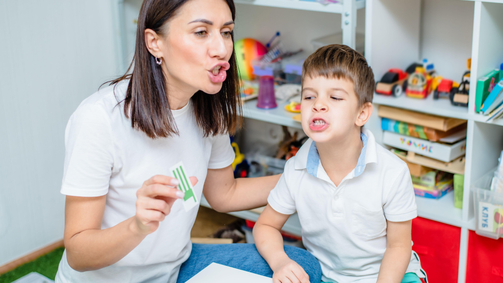 PE Teacher Ideas for Fitness Activities – Squat Exercises in Physical Education Class Women speech therapist teaches child to pronounce words sounds and letter correctly.