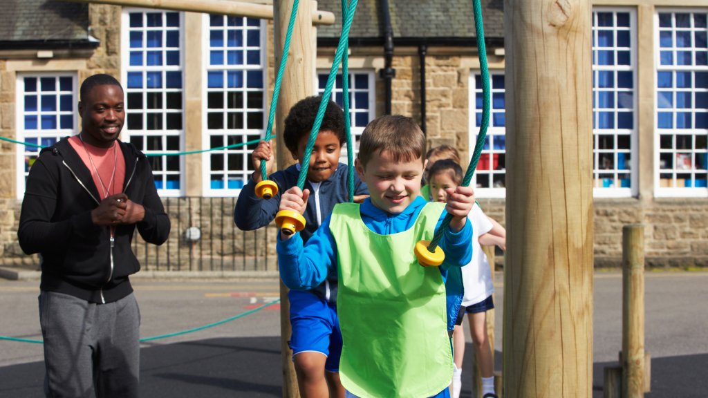PE Teacher Ideas for Fitness Activities – Squat Exercises in Physical Education Class Group of children in physical education class.